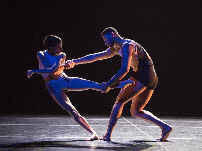 Jaqlin Medlock and Barrington Hinds in Locomotor. Barrington pulls Medlock's leg as they link hands for support.